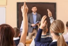 A teacher supports children in a classroom as schools call for better behavioural support for children.